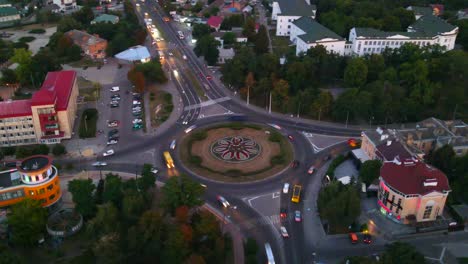 4k aerial view timelapse of roundabout road with circular cars in small european city at evening