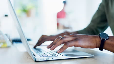 Black-man-is-typing-on-laptop,-hands-and-notes