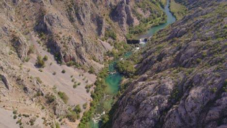 wide shot of kayaks cruising in zrmanja river turquoise blue water, aerial