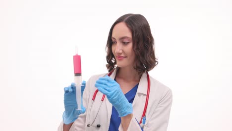 female doctor holding a large syringe with pink liquid