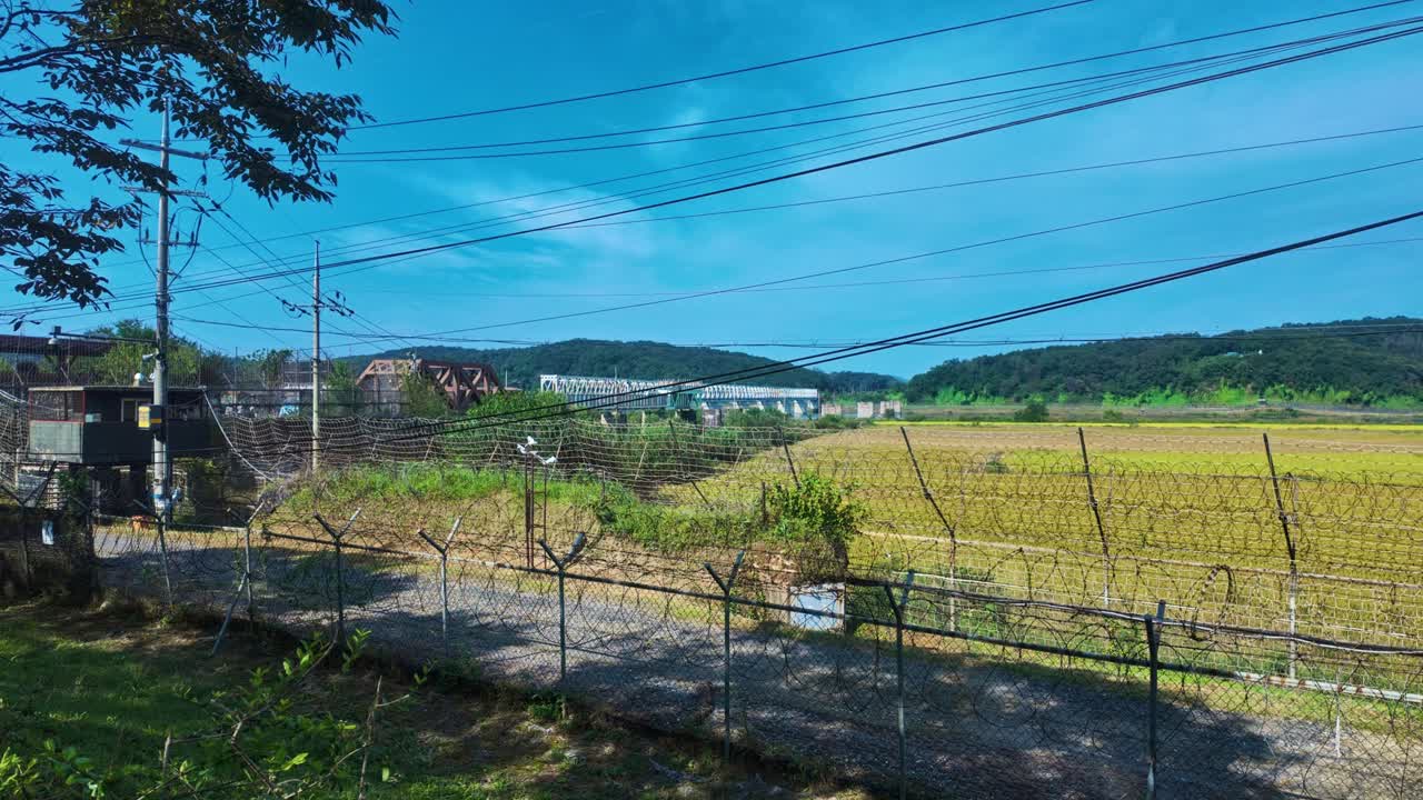 Barbed Wire Fencing At The Korean Demilitarized Zone (DMZ) Bordering North And South Korea. Panning Shot