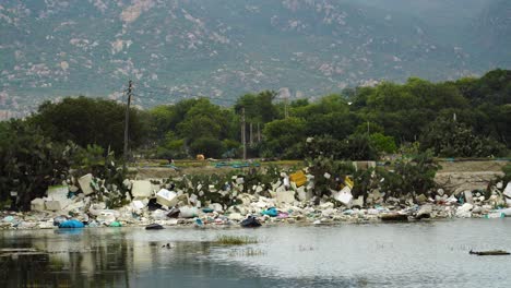 view of trash pollution on edge of riverbank at son hai in vietnam