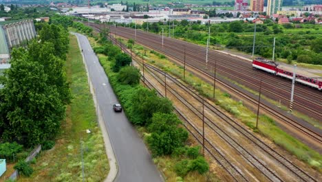 red electric train in the rural countryside - aerial shot