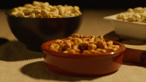 close up of bowls of cashews dry roasted peanuts and pistachio nuts in studio 2