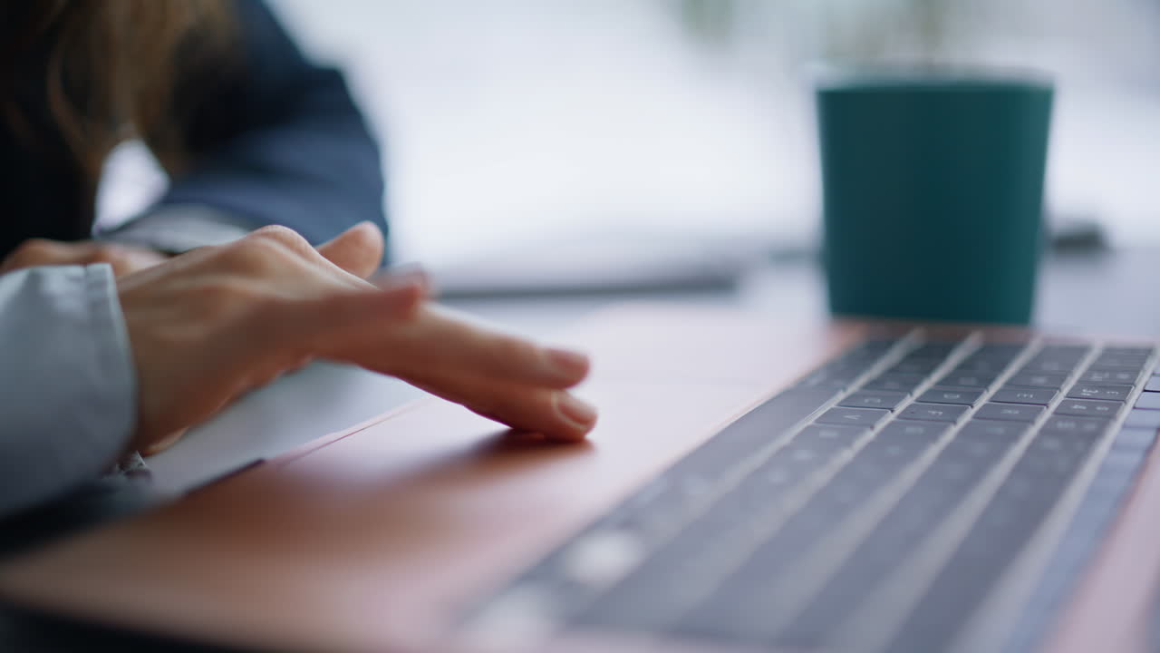 Woman hands using touchpad laptop at workplace closeup. Finger touching computer