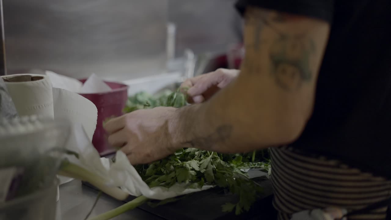 Chef preparing fresh herbs