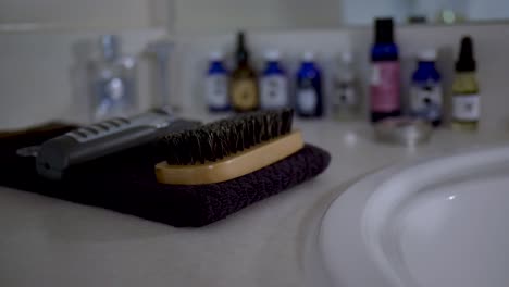 Mens-beard-and-hair-care-products-tools-on-a-bathroom-counter
