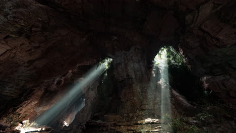 sunlight beams through a cave entrance