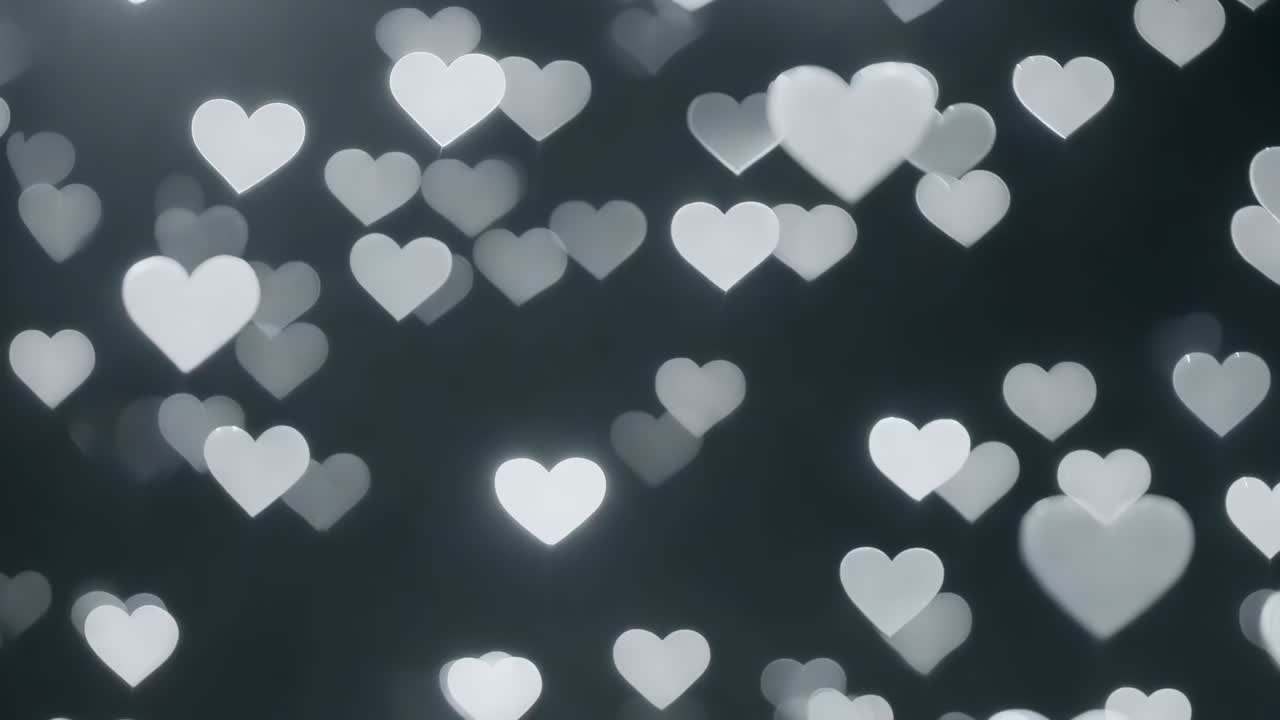 Bokeh a forma di cuore fluttuante che reagisce alle inquadrature, spostandosi verso l'interno e illuminandosi su uno sfondo scuro