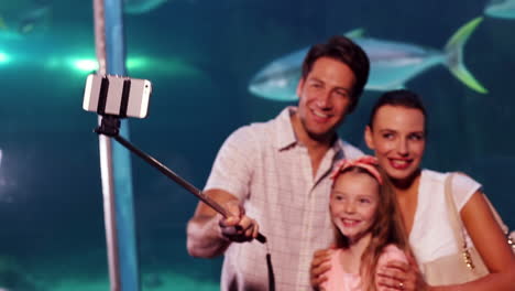 happy family using selfie stick