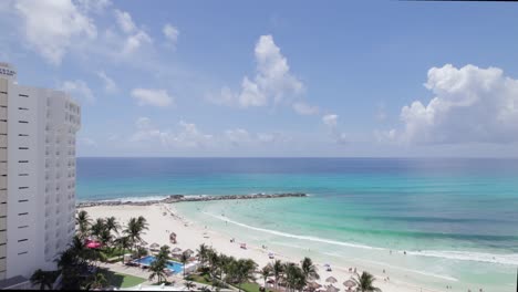 dolly in cancun beach through hotels drone shot