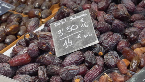 Dates-piled-up-on-a-counter-in-the-Central-Market-of-Valencia,-Spain