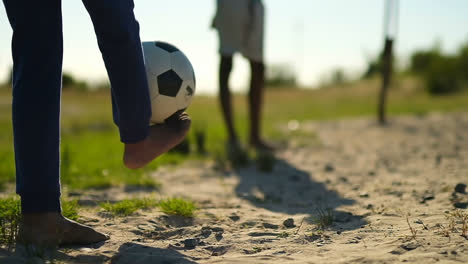 low section of boy playing football with leg 4k