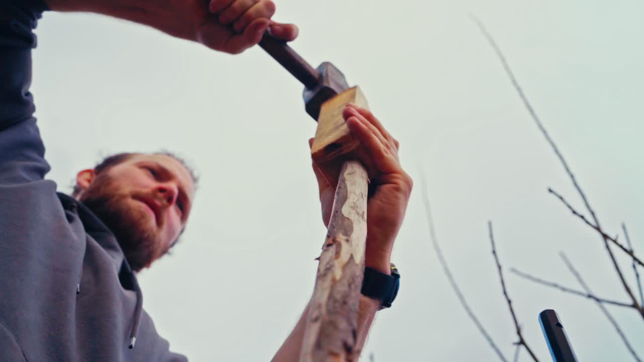 Close Up Of Man Constructing Wooden Fence In Norway