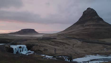 Drone-Shot-of-Kirkjufellsfoss-and-Kirkjufell-Mountain,-Snæfellsnes-Peninsula,-Iceland