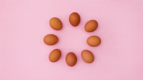 creative dance of fresh eggs on pastel pink theme. stop motion