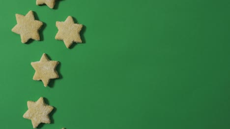 star shaped christmas cookies and copy space on green background