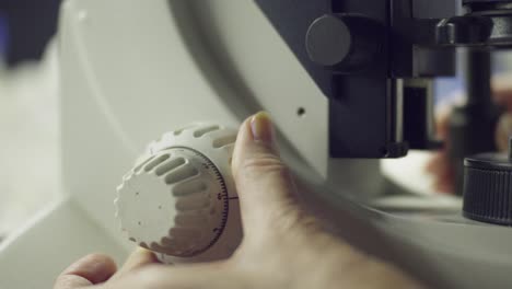 scientist operating a microscope 02