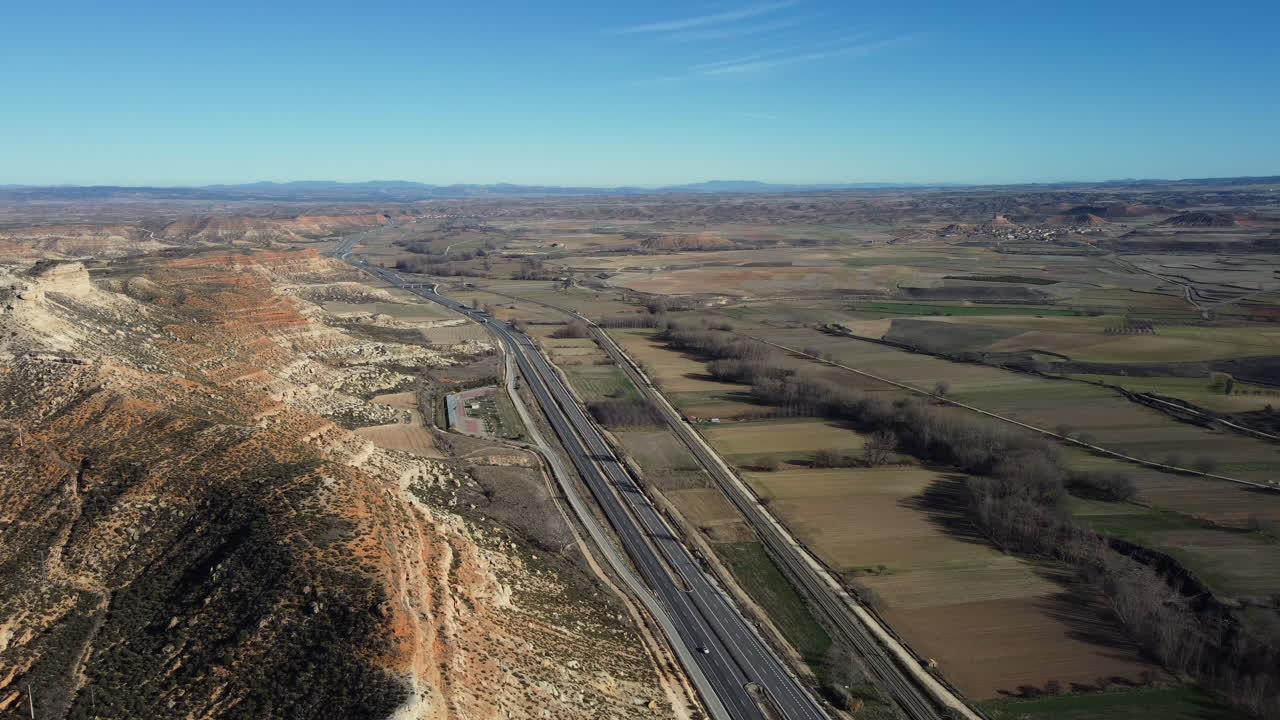 Aerial View of a Highway Cutting Through a Scenic Spanish Valley