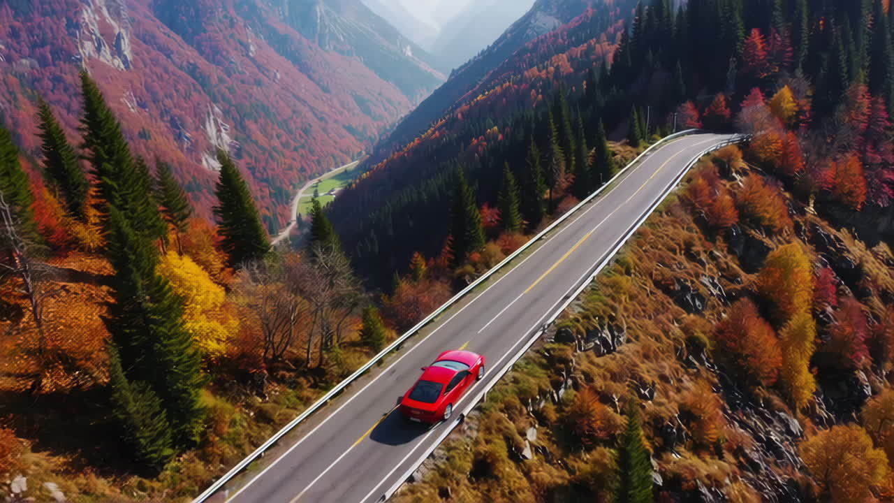 Red Car on a Winding Mountain Road in Autumn