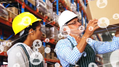 Animation-of-network-of-connections-with-icons-over-diverse-people-working-in-warehouse