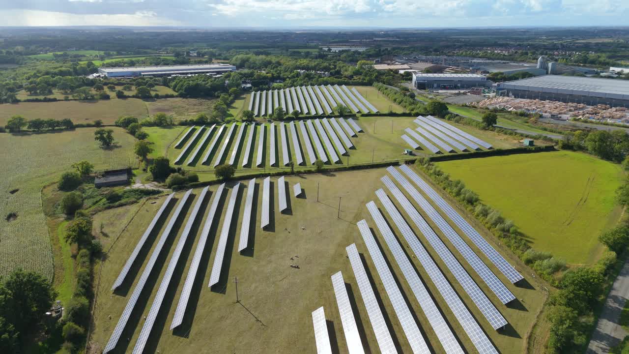 Aerial drone view of solar panels and photovoltaic cells generating energy near factories and distribution centres in Coalville, United Kingdom