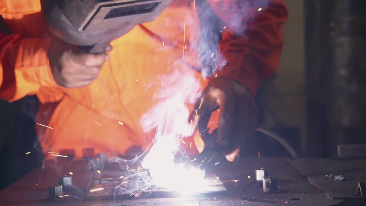 Metal welder working with arc welding machine