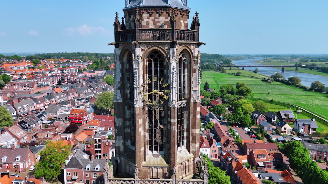 Beautiful steeple of the Cunera Church in the city of Rhenen, Province Utrecht, the Netherlands. Stunning panorama of the a green cityscape at backdrop.