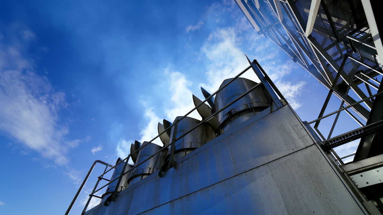 Smoke from grain elevators. Modern plant for drying seeds. White vapor released from industrial pipes of the granary.