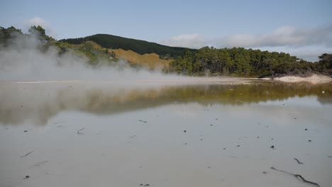 Static-shot-of-geothermal-waters-of-Wai-O-Tapu-Thermal-Wonderland-in-New-Zealand,-hot-steam-sunny-day-in-4K