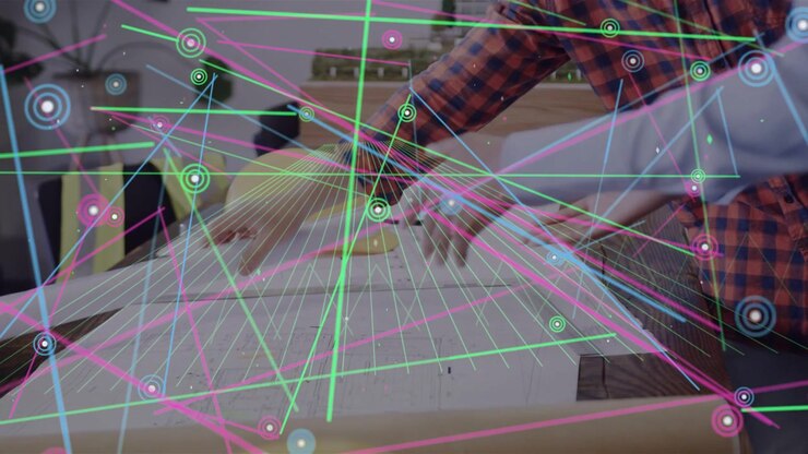 Right man reaching ruler partner smoothing sheet aligning domes for design HUD overlaying workspace