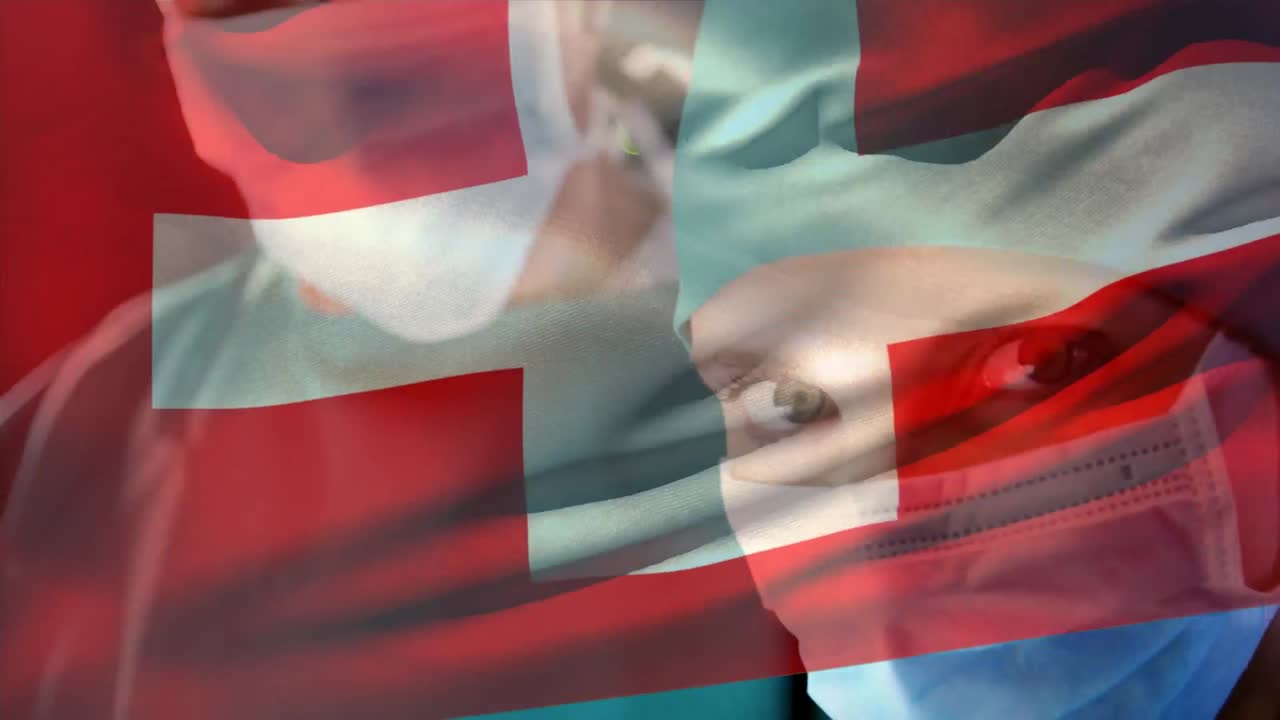 composición digital de la bandera suiza ondeando sobre una cirujana que lleva una máscara facial en el hospital