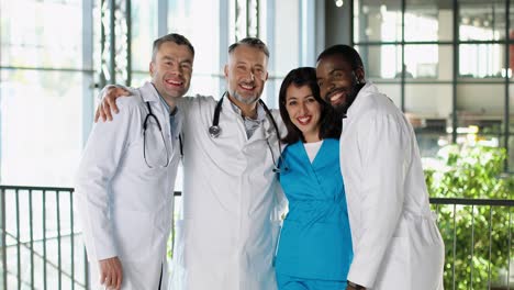 happy doctors hugging, talking and laughing