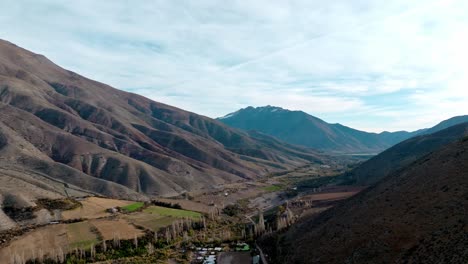 drone flyover vineyard cultivation in limarí valley, surrounded by rugged mountains