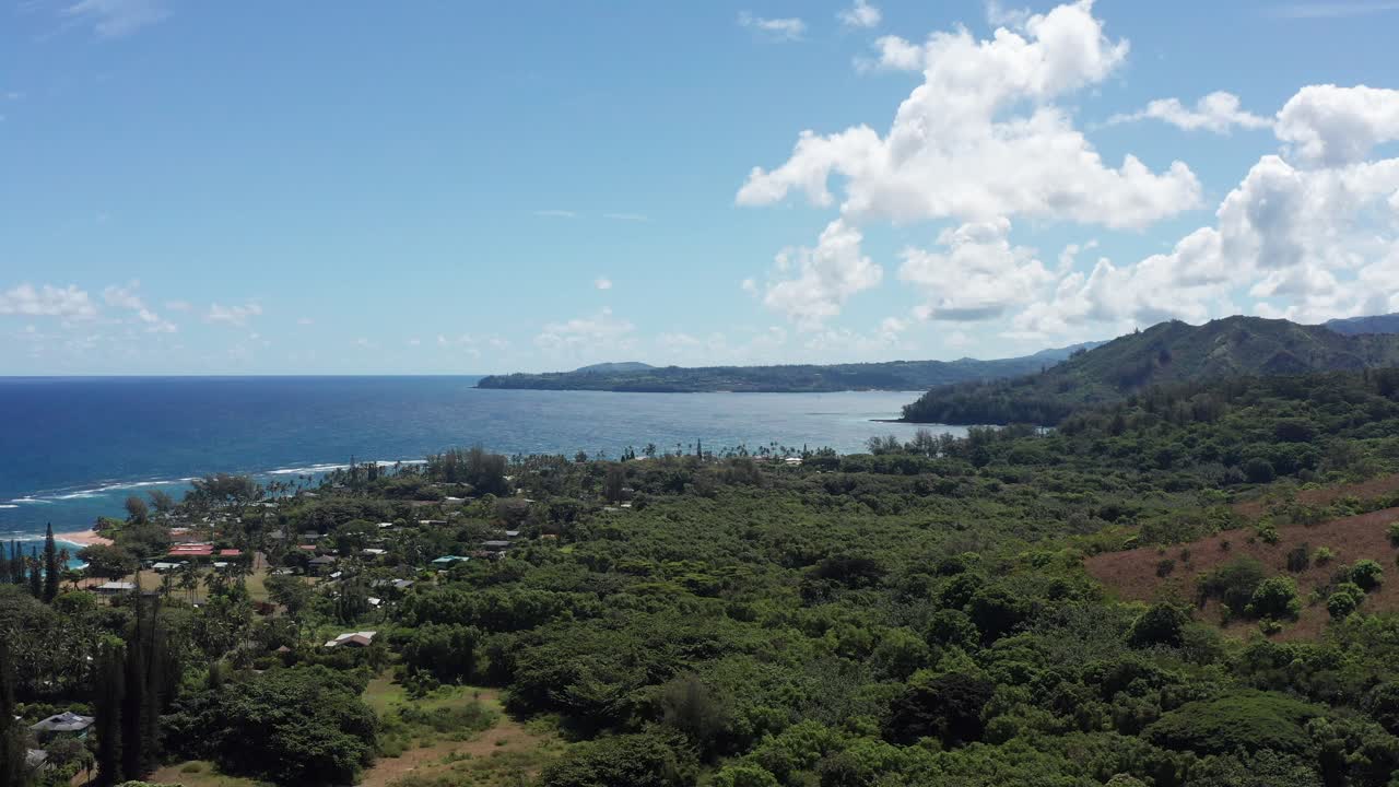 Aerial descending dolly shot of the small Hawaiian town Haena on the island of Kaua'i