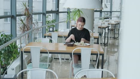 woman eating lunch in a modern cafe