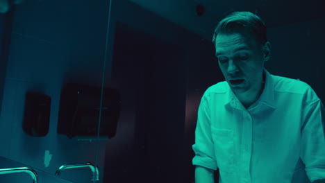 man in a bathroom, looking troubled