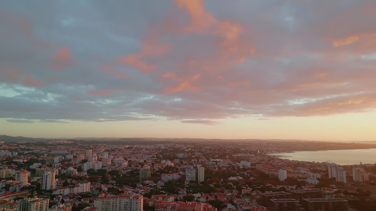 Panoramic view coastal city under picturesque golden sunset. Orange sundown