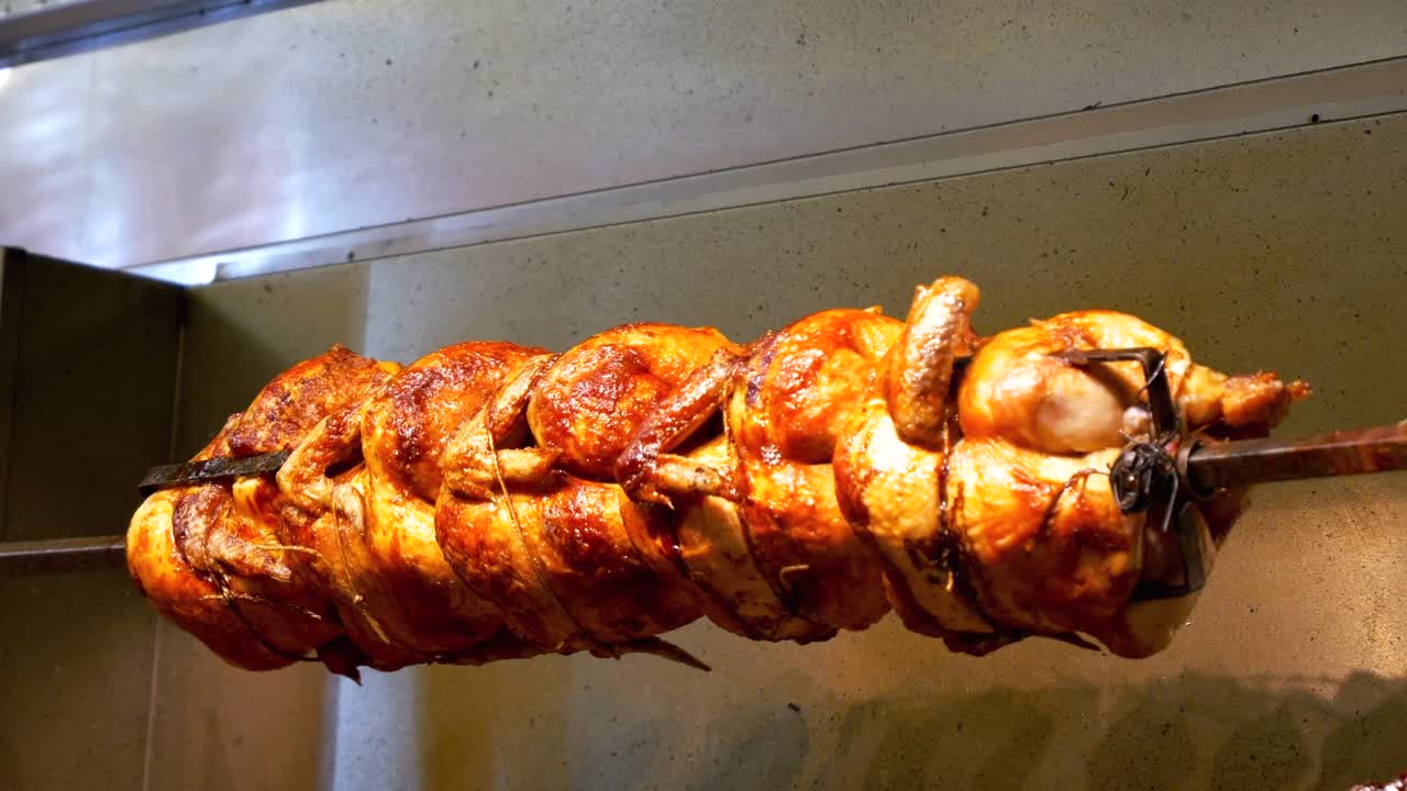 Premium Stock Video Golden Chicken Roasts On A Rotisserie