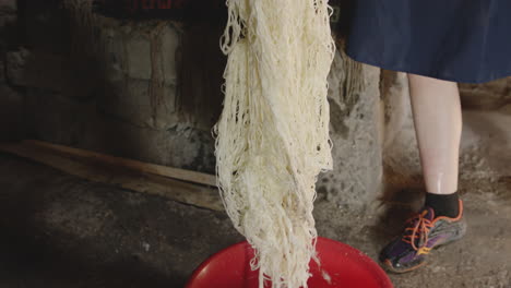 hand lifts string cheese, finished fresh cheese, chobareti georgia, medium shot