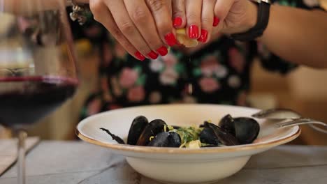 woman eating mussels