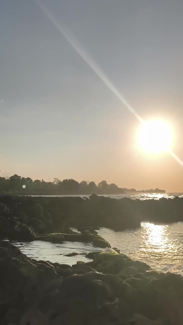 Golden Sunset Over Rocky Coastline and Tide Pools