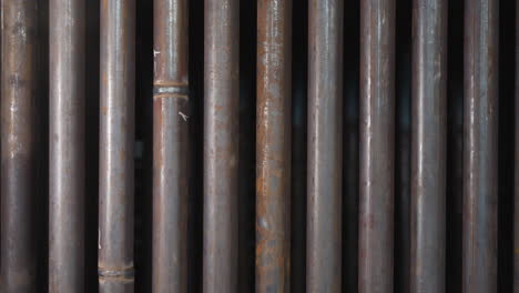 metal pipes row with welding seams in factory storehouse