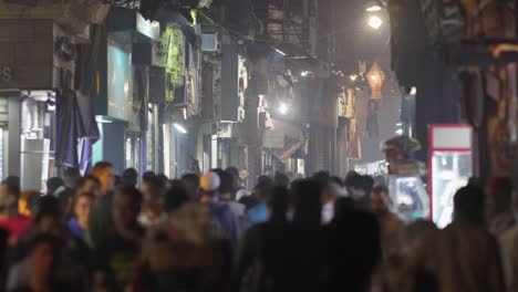 unrecognizable people walk the busy el moez street in old cairo, egypt.  al-muizz li-din allah al-fatimi street - major north-to-south street in the walled city of historic cairo