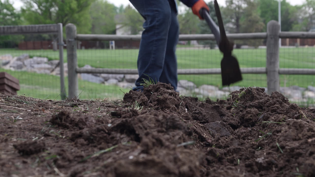 Man Is Digging On The Yard Using Pick Mattock