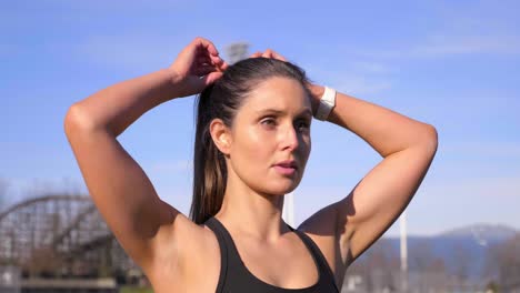 Attractive-athletic-woman-tying-up-hair-before-run-Medium-shot