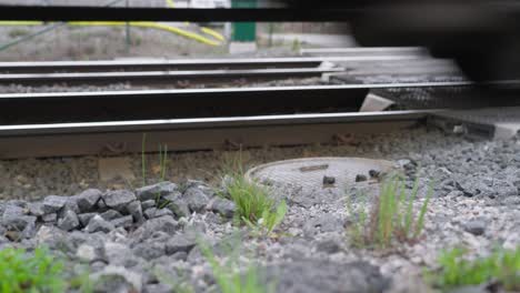 the wheels of train on the railway track passing by camera