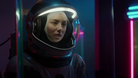 woman in astronaut helmet with neon lighting