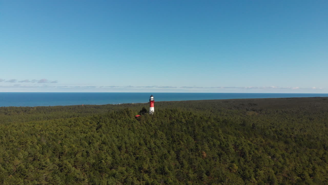 Red and white lighthouse in the forest