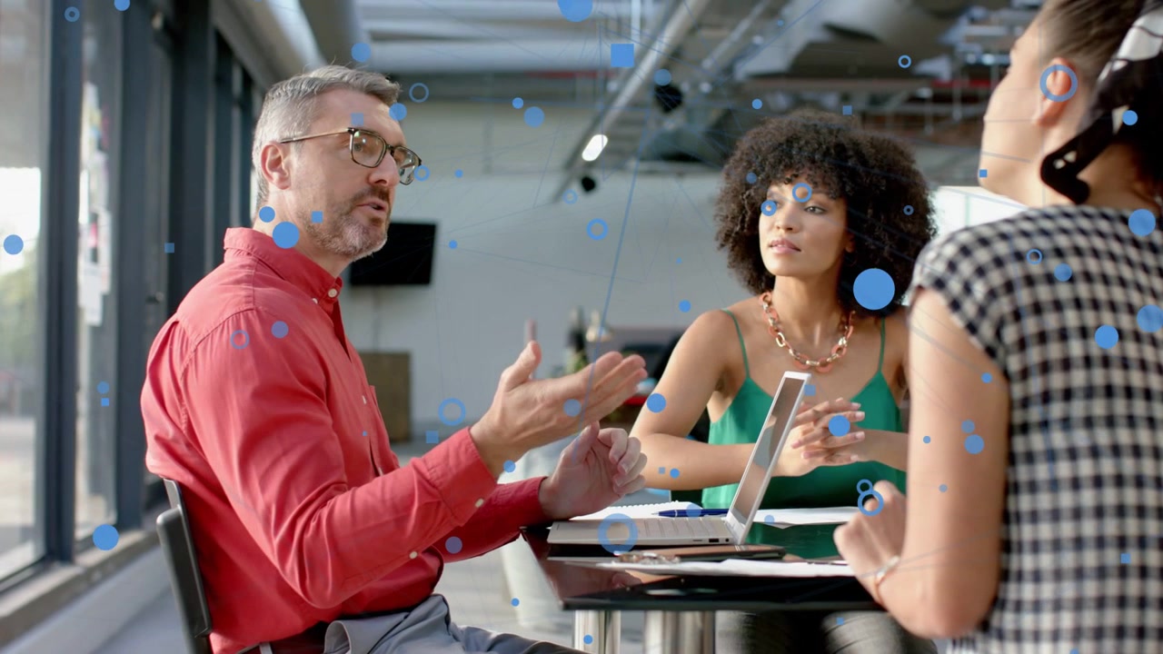 Team in meeting left man starting typing laptop to set sales plan blue circles overlay tablet